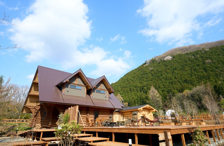 サウナの森 水沼ヴィレッジのログハウスと山の風景